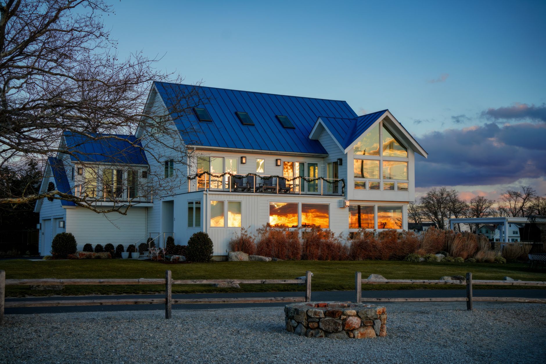 A stately home illuminated at dusk.