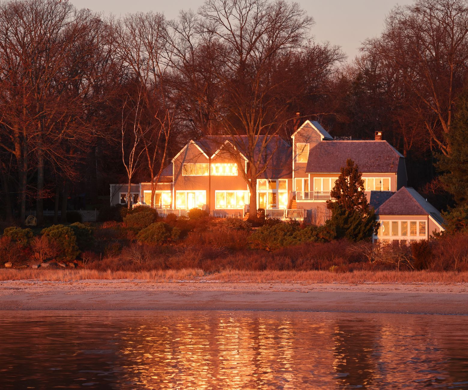 A lakeside home at dusk.